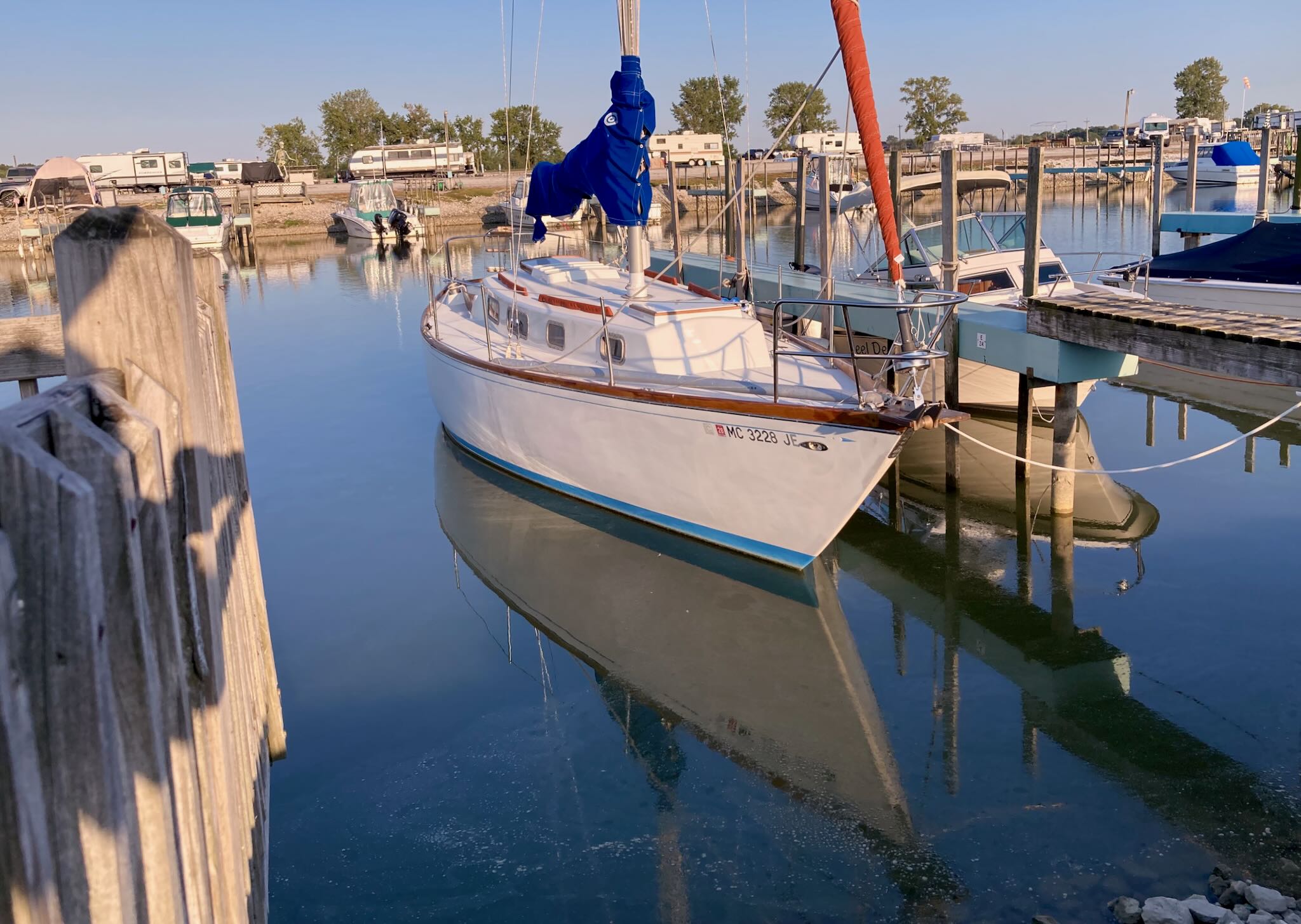 Altair, a Tartan 34C sailboat, docked in calm waters and warm sunlight.